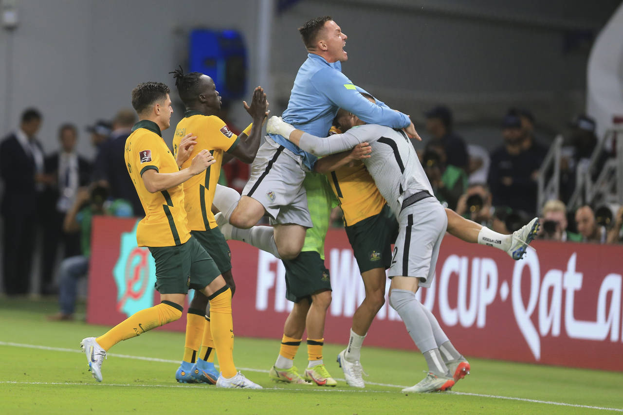 FILE - Australian players celebrate after winning in a penalty shoot-out during the World Cup 2022 ...
