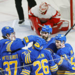 
              Buffalo Sabres defenseman Rasmus Dahlin (26) celebrates his goal with teammates during the third period of an NHL hockey game against the Detroit Red Wings, Monday, Oct. 31, 2022, in Buffalo, N.Y. (AP Photo/Jeffrey T. Barnes)
            