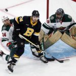 
              Boston Bruins' Jake DeBrusk (74) and Minnesota Wild's Matt Dumba (24) battle for the puck in front of Wild goalie Marc-Andre Fleury (29) during the first period of an NHL hockey game, Saturday, Oct. 22, 2022, in Boston. (AP Photo/Michael Dwyer)
            