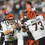 
              Cincinnati Bengals quarterback Joe Burrow (9) is rushed by Cleveland Browns defensive end Myles Garrett, center, with Bengals offensive tackle Jonah Williams (73) defending during the second half of an NFL football game in Cleveland, Monday, Oct. 31, 2022. (AP Photo/David Richard)
            