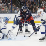 
              Tampa Bay Lightning's Andrei Vasilevskiy, left, makes a save as teammate Cal Foote, right, and Columbus Blue Jackets' Jakub Voracek look for the rebound during the second period of an NHL hockey game Friday, Oct. 14, 2022, in Columbus, Ohio. (AP Photo/Jay LaPrete)
            
