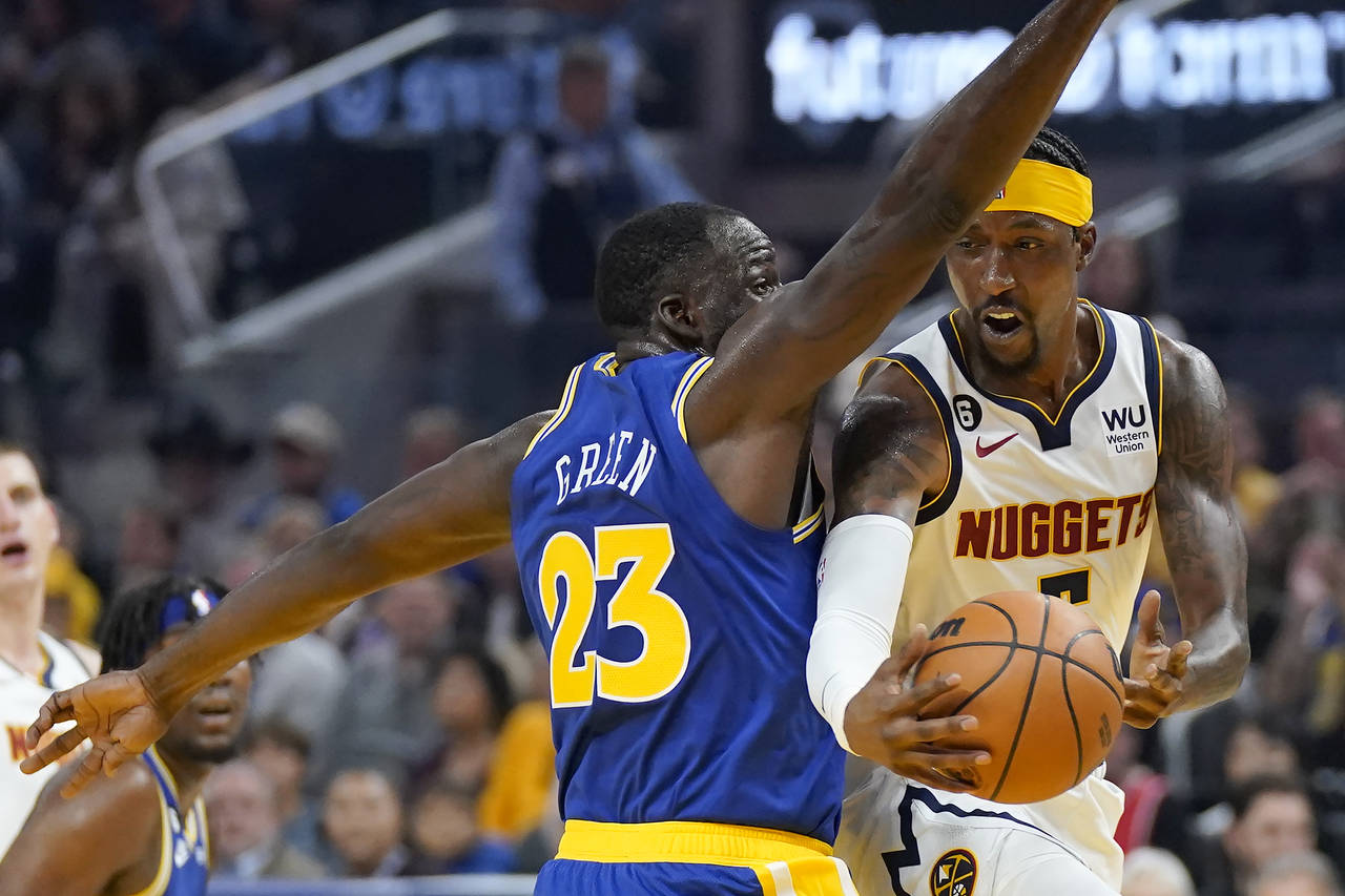 Denver Nuggets guard Kentavious Caldwell-Pope, right, passes the ball while defended by Golden Stat...