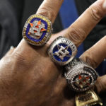 
              A fan holds up his hand with replica World Series rings ahead of Game 1 of baseball's American League Championship Series between the Houston Astros and the New York Yankees, Wednesday, Oct. 19, 2022, in Houston. (AP Photo/Eric Gay)
            