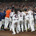 
              Houston Astros designated hitter Yordan Alvarez, center, celebrates teammates after hitting a three-run, walk off home run against the Seattle Mariners during the ninth inning in Game 1 of an American League Division Series baseball game in Houston,Tuesday, Oct. 11, 2022. (AP Photo/Kevin M. Cox)
            