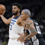 
              Minnesota Timberwolves center Karl-Anthony Towns handles the ball against San Antonio Spurs forward Jeremy Sochan (10) during the first half of an NBA basketball game, Monday, Oct. 24, 2022, in Minneapolis. (AP Photo/Abbie Parr)
            