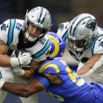 
              Carolina Panthers running back Christian McCaffrey, left, is tackled by Los Angeles Rams linebacker Justin Hollins during the first half of an NFL football game Sunday, Oct. 16, 2022, in Inglewood, Calif. (AP Photo/Ashley Landis)
            