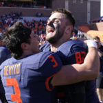 
              Illinois quarterback Tommy DeVito (3) and tight end Luke Ford celebrate the team's 26-14 win over Minnesota after an NCAA college football game Saturday, Oct. 15, 2022, in Champaign, Ill. (AP Photo/Charles Rex Arbogast)
            