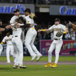 
              Members of the San Diego Padres celebrate after the Padres defeated the Los Angeles Dodgers 5-3 in Game 4 of a baseball NL Division Series, Saturday, Oct. 15, 2022, in San Diego.(AP Photo/Ashley Landis)
            