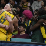 
              Australian players embrace during their bronze medal win over Canada at the women's Basketball World Cup in Sydney, Australia, Saturday, Oct. 1, 2022. (AP Photo/Mark Baker)
            