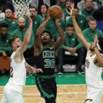
              Boston Celtics' Marcus Smart goes to the basket between Cleveland Cavaliers' Jarrett Allen, right, and Dean Wade during the first quarter of an NBA basketball game Friday, Oct. 28, 2022, in Boston. (AP Photo/Winslow Townson)
            