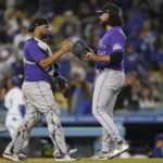 
              Colorado Rockies catcher Elias Diaz (35) clelebrates with relief pitcher Justin Lawrence (61) after their 2-1 win over the Los Angeles Dodgers in a baseball game in Los Angeles, Monday, Oct. 3, 2022. (AP Photo/Ashley Landis)
            
