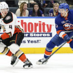 
              Anaheim Ducks defenseman Cam Fowler (4) and New York Islanders center Mathew Barzal (13) fight for the puck during the second period of an NHL hockey game, Saturday, Oct. 15, 2022, in Elmont, N.Y. (AP Photo/Julia Nikhinson)
            