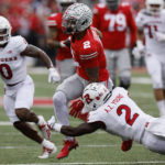 
              Ohio State receiver Emeka Egbuka, center, turns up field between Rutgers defensive back Christian Izien, left, and defensive back Avery Young during the first half of an NCAA college football game, Saturday, Oct. 1, 2022, in Columbus, Ohio. (AP Photo/Jay LaPrete)
            