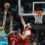 
              Charlotte Hornets guard James Bouknight, left, shoots over New Orleans Pelicans forwards Naji Marshall, center, and Larry Nance Jr., right, during the first half of an NBA basketball game Friday, Oct. 21, 2022, in Charlotte, N.C. (AP Photo/Rusty Jones)
            