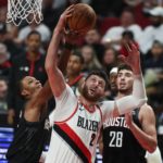 
              Houston Rockets forward Jabari Smith Jr., left, and Portland Trail Blazers center Jusuf Nurkic, right, battle for a rebound during the first quarter of an NBA basketball game in Portland, Ore., Friday, Oct. 28, 2022. (AP Photo/Steve Dipaola)
            