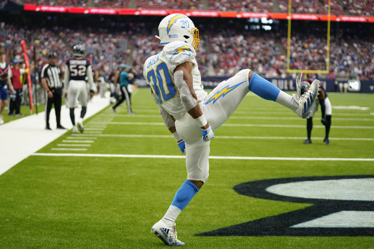 Los Angeles Chargers running back Austin Ekeler (30) celebrates his touchdown against the Houston T...