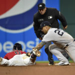 
              Cleveland Guardians' Andres Gimenez, left, slides safely into second base before a tag by New York Yankees second baseman Gleyber Torres (25) after hitting a single and advancing to second on a fielding error by Harrison Bader in the seventh inning of Game 4 of a baseball AL Division Series, Sunday, Oct. 16, 2022, in Cleveland. (AP Photo/Phil Long)
            