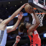 
              Memphis Grizzlies forward Santi Aldama, left, blocks a shot-attempt by Houston Rockets guard Jalen Green (4) during the first half of an NBA basketball game Friday, Oct. 21, 2022, in Houston. (AP Photo/Michael Wyke)
            