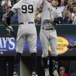 
              New York Yankees' Kyle Higashioka, right, celebrates his solo home run with Aaron Judge during the eighth inning in the first baseball game of a doubleheader against the Texas Rangers in Arlington, Texas, Tuesday, Oct. 4, 2022. (AP Photo/LM Otero)
            
