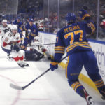 
              Florida Panthers and Buffalo Sabres players watch as the puck flies past Sabres' JJ Peterka during an NHL hockey game Saturday, Oct. 15, 2022, in Buffalo, N.Y. (Joseph Cooke/The Buffalo News via AP)
            
