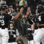 
              Chicago White Sox's Jose Abreu (79) greets Eloy Jimenez at home after they scored on hit by Gavin Sheets off Minnesota Twins starting pitcher Josh Winder during the third inning of a baseball game Tuesday, Oct. 4, 2022, in Chicago. (AP Photo/Charles Rex Arbogast)
            