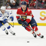 
              Florida Panthers defenseman Gustav Forsling (42) and Tampa Bay Lightning left wing Brandon Hagel (38) battle for the puck during the first period of an NHL hockey game, Friday, Oct. 21, 2022, in Sunrise, Fla. (AP Photo/Wilfredo Lee )
            