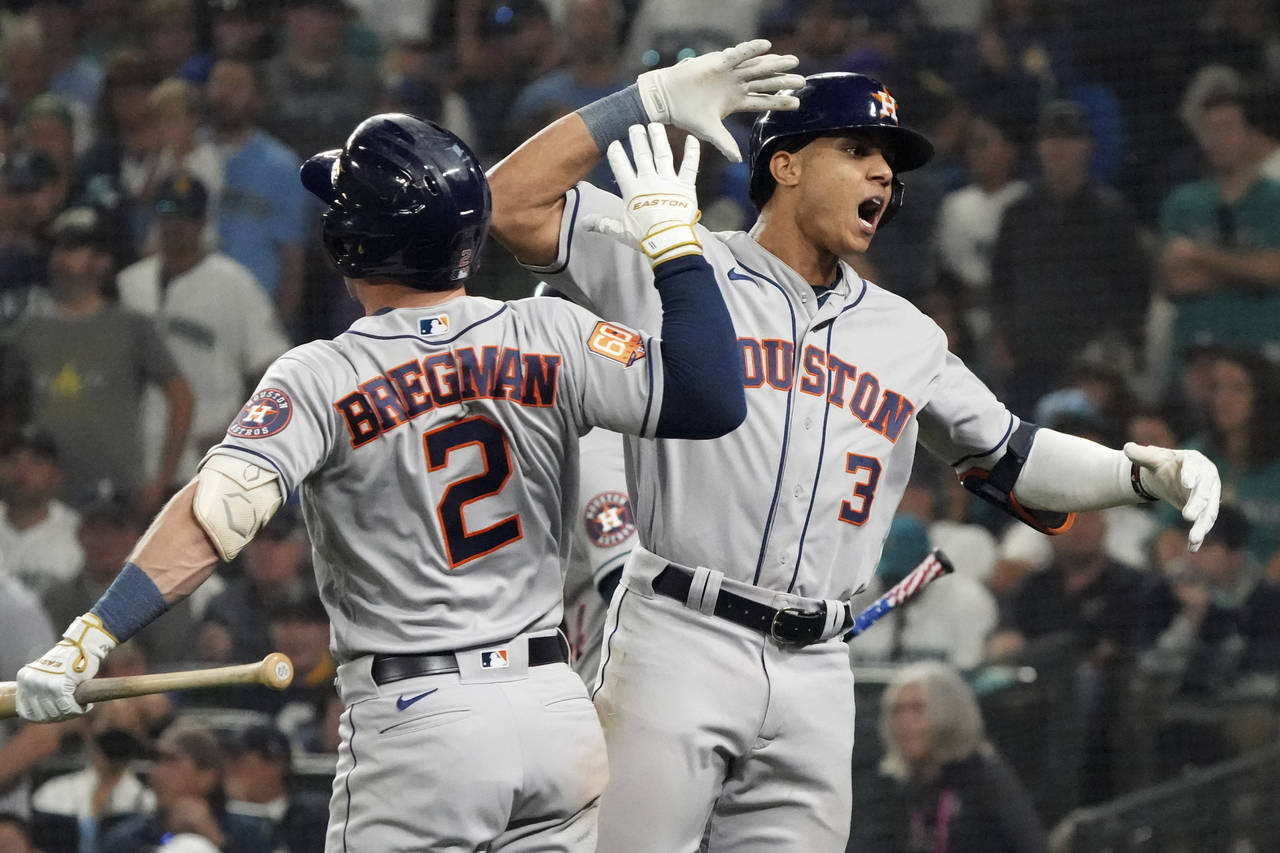 Houston Astros' Jeremy Pena (3) celebrates a home run against the Seattle Mariners with Alex Bregma...
