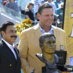 
              Former Jacksonville Jaguars lineman Tony Boselli, right, poses while being honored with owner Shad Khan, left, during halftime of an NFL football game against the Houston Texans in Jacksonville, Fla., Sunday, Oct. 9, 2022. (AP Photo/Phelan M. Ebenhack)
            