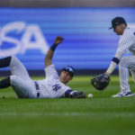 
              New York Yankees left fielder Oswaldo Cabrera, left, can't make the catch on a blooping base hit by Cleveland Guardians Jose Ramirez as third baseman Josh Donaldson (28) picks up the ball during the tenth inning of Game 2 of an American League Division baseball series, Friday, Oct. 14, 2022, in New York. (AP Photo/John Minchillo)
            