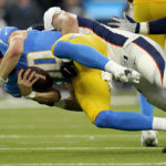
              Denver Broncos defensive tackle Mike Purcell sacks Los Angeles Chargers quarterback Justin Herbert (10) during the first half of an NFL football game, Monday, Oct. 17, 2022, in Inglewood, Calif. (AP Photo/Mark J. Terrill)
            