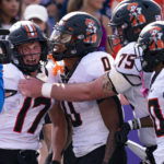 
              Oklahoma State wide receiver John Paul Richardson (17) is congratulated by teammates, running back Ollie Gordon (0), offensive lineman Eli Russ (75), and wide receiver Brennan Presley (80) after scoring a touchdown during the first half of an NCAA college football game against TCU in Fort Worth, Texas, Saturday, Oct. 15, 2022. (AP Photo/Sam Hodde)
            