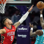 
              New Orleans Pelicans center Willy Hernangomez (9) defends on a shot by Charlotte Hornets guard Terry Rozier (3) during the first half of an NBA basketball game Friday, Oct. 21, 2022, in Charlotte, N.C. (AP Photo/Rusty Jones)
            