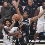
              New Orleans Pelicans' Brandon Ingram (14) drives past Brooklyn Nets' Kyrie Irving (11) and Kevin Durant during the first half of an NBA basketball game Wednesday, Oct. 19, 2022, in New York. (AP Photo/Frank Franklin II)
            