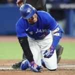 
              Toronto Blue Jays' George Springer reacts after being hit by a pitch from Seattle Mariners' Luis Castillo during the eighth inning of Game 1 of a baseball AL wild-card series, Friday, Oct. 7, 2022, in Toronto. (Nathan Denette/The Canadian Press via AP)
            