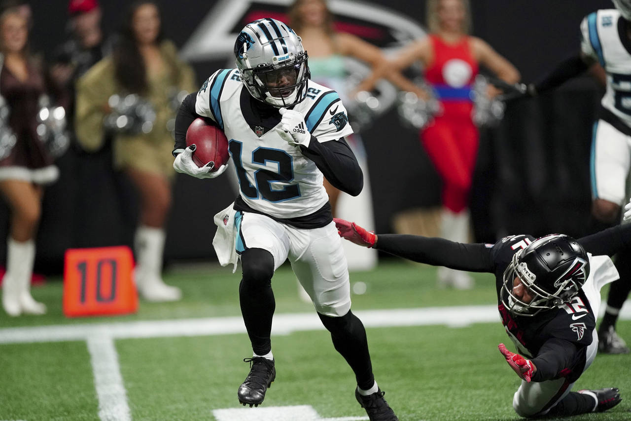Carolina Panthers wide receiver Shi Smith, left, runs with the ball as Atlanta Falcons wide receive...