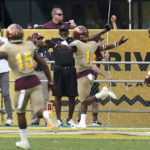 
              Arizona State defensive back Jordan Clark (1) celebrates after his interception for a touchdown against Washington as Arizona State defensive back Khoury Bethley (15) and linebacker Merlin Robertson (8) follow during the first half of an NCAA college football game in Tempe, Ariz., Saturday, Oct. 8, 2022. (AP Photo/Ross D. Franklin)
            