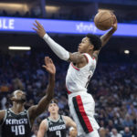 
              Portland Trail Blazers guard Anfernee Simons (1) goes up for a shot over Sacramento Kings forward Harrison Barnes (40) during the first quarter of an NBA basketball game in Sacramento, Calif., Wednesday, Oct. 19, 2022. (AP Photo/José Luis Villegas)
            