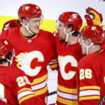 
              Calgary Flames forward Brett Ritchie, second from right, celebrates his goal against the Carolina Hurricanes with defenseman Nikita Zadorov, back left, and defenseman Michael Stone during the second period of an NHL hockey game Saturday, Oct. 22, 2022, in Calgary, Alberta. (Jeff McIntosh/The Canadian Press via AP)
            