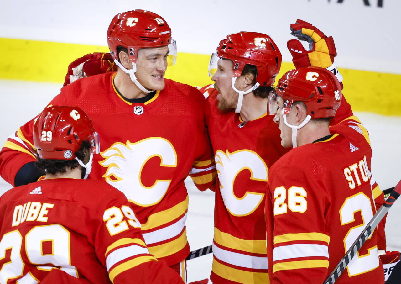 Calgary Flames forward Brett Ritchie, second from right, celebrates his goal against the Carolina H...