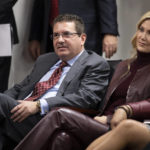 
              FILE - Washington Redskins owner Dan Snyder, left, and his wife Tanya Snyder, listen to head coach Ron Rivera during a news conference at the team's NFL football training facility in Ashburn, Va., in this Thursday, Jan. 2, 2020, file photo. Few NFL teams have managed to lose as much as Washington has since Daniel Snyder was part of a group that purchased the franchise for a then-record $800 million in 1999. (AP Photo/Alex Brandon, File)
            