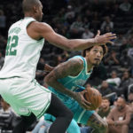 
              Charlotte Hornets' Kelly Oubre Jr., right, looks for an opening around Boston Celtics' Al Horford, left, in the first half of a preseason NBA basketball game, Sunday, Oct. 2, 2022, in Boston. (AP Photo/Steven Senne)
            