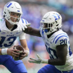 
              Duke quarterback Riley Leonard (13) fakes a handoff to running back Jaquez Moore (20) during the first half of an NCAA college football game against Miami, Saturday, Oct. 22, 2022, in Miami Gardens, Fla. (AP Photo/Wilfredo Lee)
            