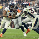 
              Denver Broncos quarterback Russell Wilson (3) hands off to running back Javonte Williams (33) during the second half of an NFL football game against the Las Vegas Raiders, Sunday, Oct. 2, 2022, in Las Vegas. (AP Photo/David Becker)
            