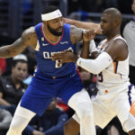 
              Los Angeles Clippers forward Marcus Morris Sr., left, drives into Phoenix Suns guard Chris Paul during the first half of an NBA basketball game, Sunday, Oct. 23, 2022, in Los Angeles. (AP Photo/Alex Gallardo)
            