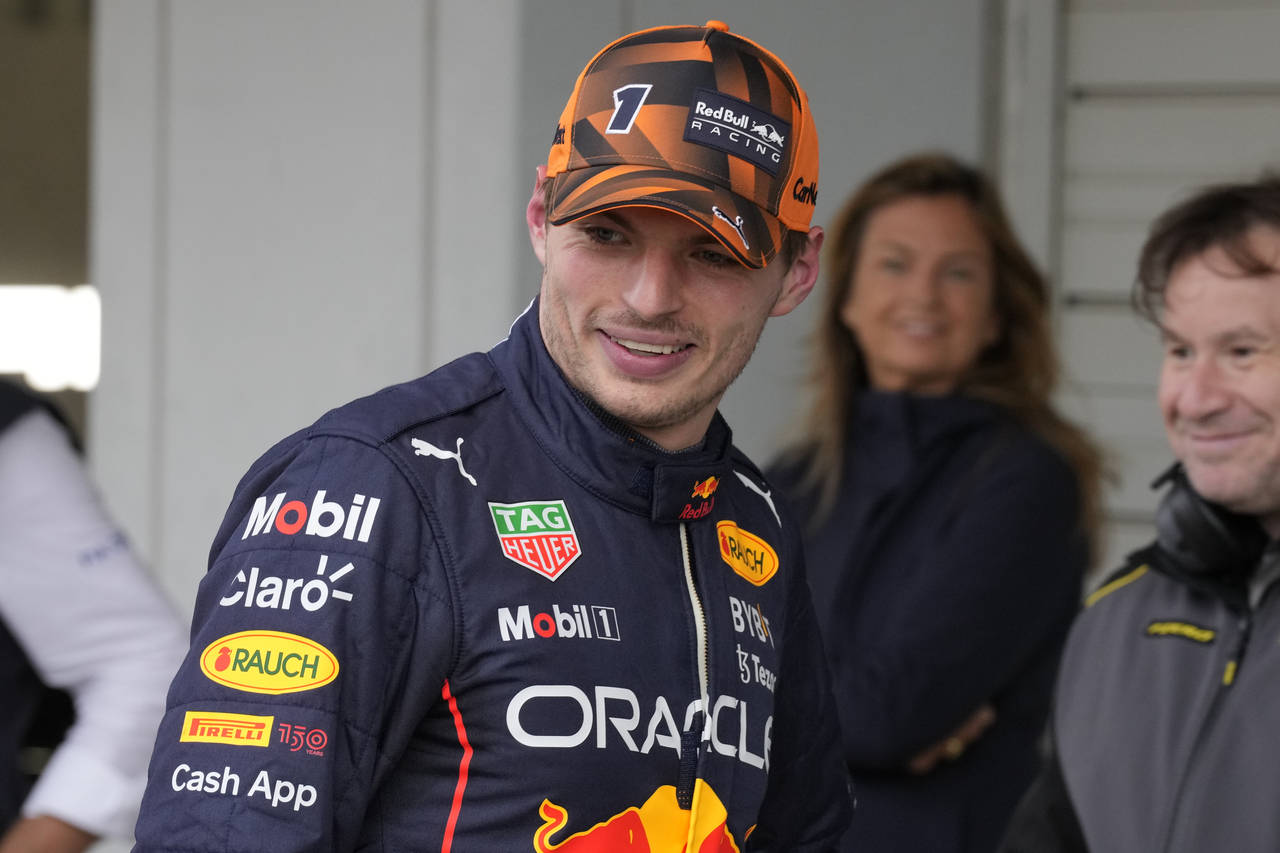 Red Bull driver Max Verstappen of the Netherlands smiles after the qualifying session of the Japane...
