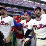 
              Philadelphia Phillies' Bryce Harper and his teammmates celebrate a win over the Atlanta Braves after Game 4 of baseball's National League Division Series, Saturday, Oct. 15, 2022, in Philadelphia. The Philadelphia Phillies won, 8-3. (AP Photo/Matt Rourke)
            