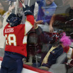 
              Florida Panthers left wing Rudolfs Balcers (38) celebrates with fans after scoring during the second period of an NHL hockey game against the Tampa Bay Lightning, Friday, Oct. 21, 2022, in Sunrise, Fla. (AP Photo/Wilfredo Lee )
            