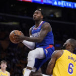 
              Los Angeles Clippers guard John Wall, left, shoots as Los Angeles Lakers forward LeBron James defends during the first half of an NBA basketball game Thursday, Oct. 20, 2022, in Los Angeles. (AP Photo/Mark J. Terrill)
            