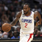 
              FILE - Los Angeles Clippers forward Kawhi Leonard dribbles down the court during the first half of a preseason NBA basketball game against the Minnesota Timberwolves, Oct. 9, 2022, in Los Angeles. Leonard and Paul George are healthy again heading into their fourth season together, raising the Clippers' hopes of winning the franchise's first championship sky-high. (AP Photo/Raul Romero Jr., File)
            