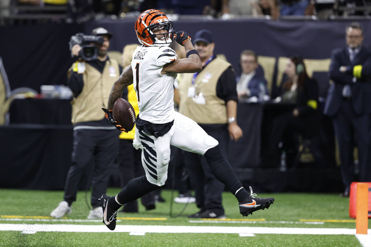 Cincinnati Bengals wide receiver Ja'Marr Chase (1) smiles as he runs for a touchdown against the Ne...